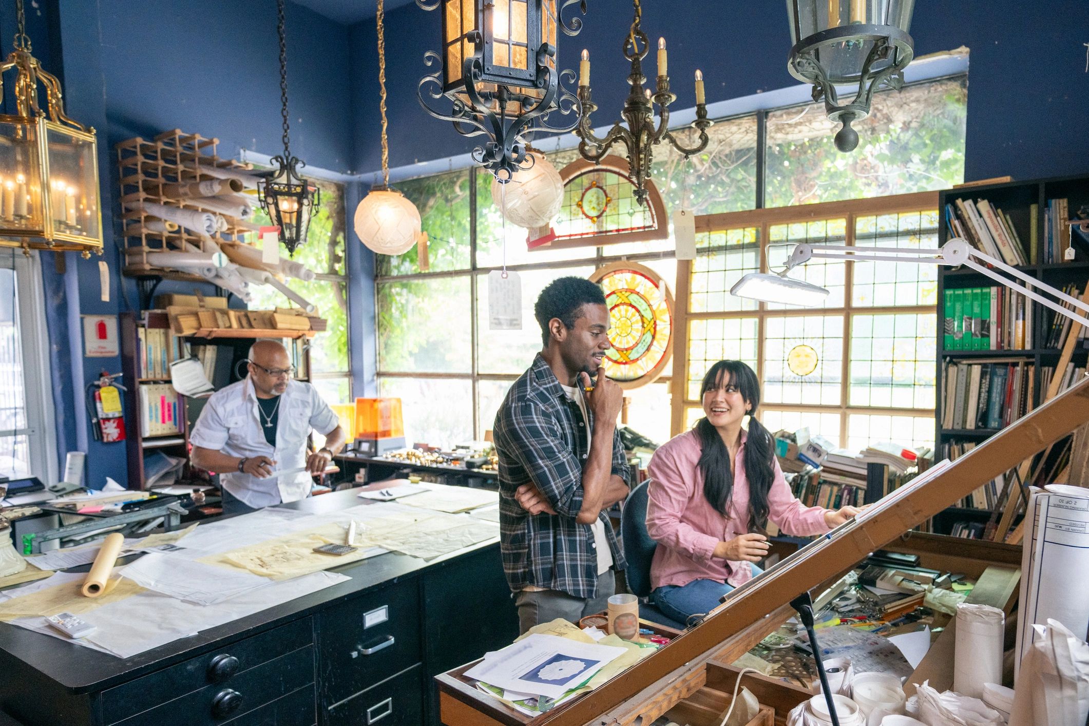 Group of inventors and technical collaborators working together in a studio workshop